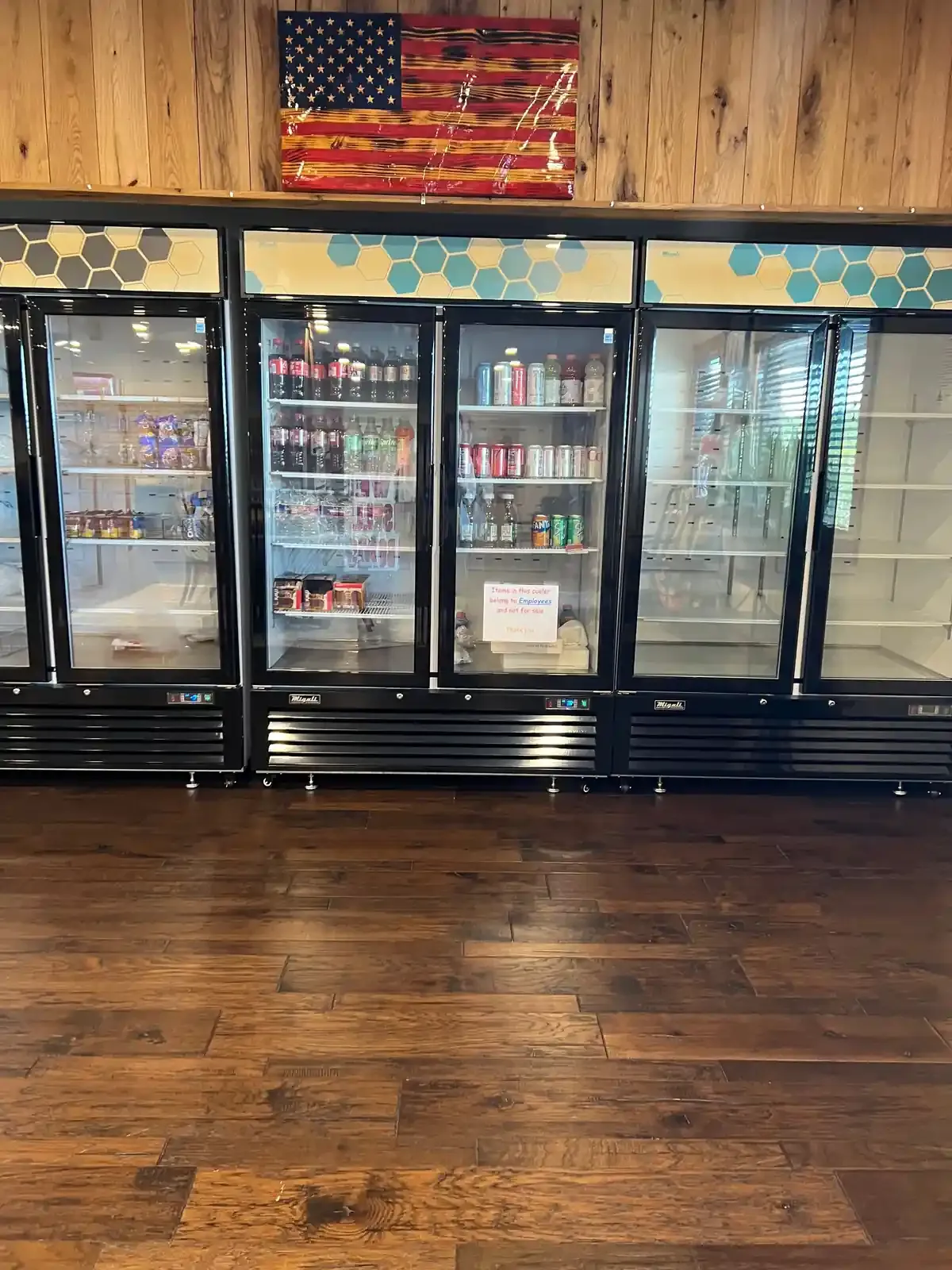 Wall of clear door refrigerators with beverages